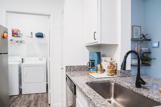 Renovated kitchen with stylish designer tile backsplash and granite countertops