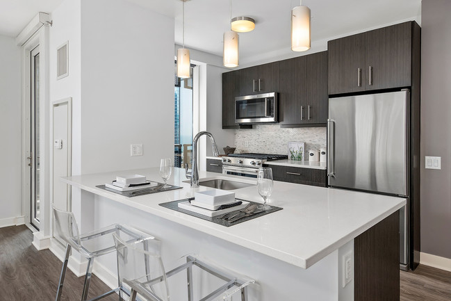 Espresso Cabinetry with Glossy White Duotone Cabinets - Moment Apartments