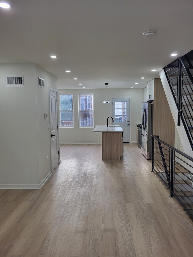 Living room to kitchen and walkout balcony view - 1164 Atwood Rd