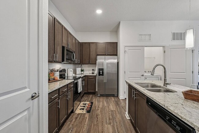 Elevate your lifestyle at San Marco Promenade Apartments. Enjoy modern kitchens with sleek appliances and stylish finishes, perfect for culinary enthusiasts. Ready to make this space your own? Contact us today for a tour! - San Marco Promenade Apartments