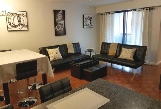 Looking towards the balcony from the living room, dining area and kitchen. - 516 S 12th St Unit Apt B