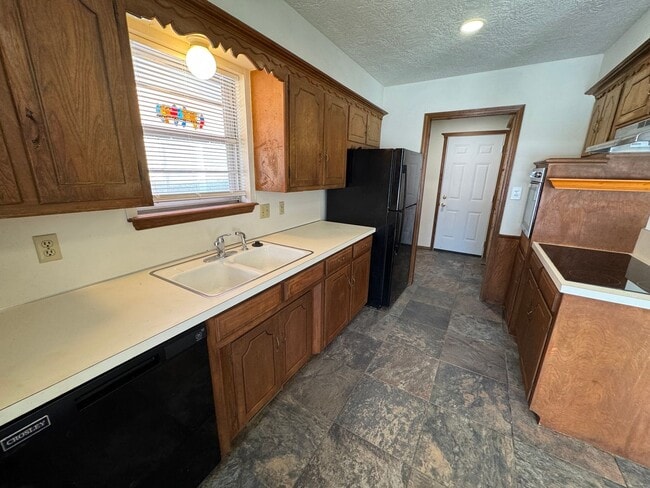 Photo - 3 bed, 2 bath, 2 car with 2 extra living spaces and new appliances, paint and carpet! Located clo...