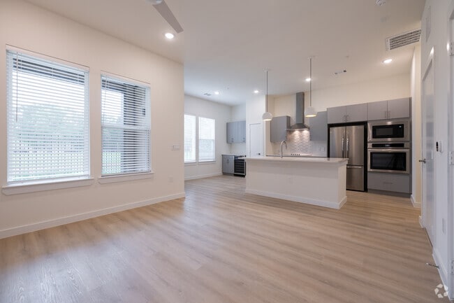 1BR, 1.5BA - 812SF - Living room, Kitchen, Dining Room - Oasis at Woodland Townhomes