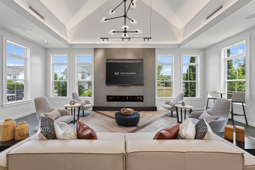 Seating faces in from four sides, which turns the fireplace into a gathering point.