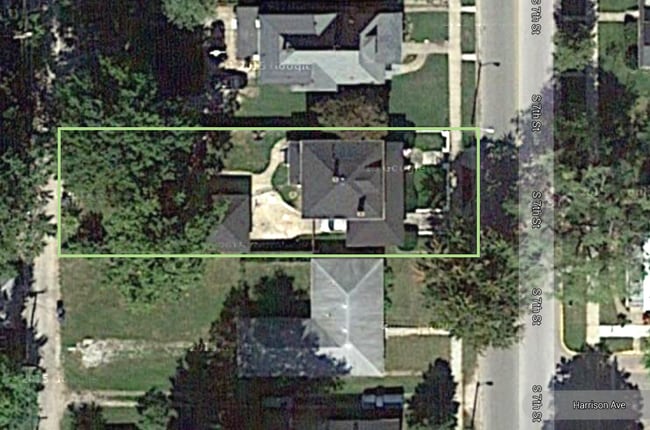 This aerial photo shows the separate two-car garage, the fenced in back yard, the cover front porch and covered driveway parking. - 1425 South 7th Street