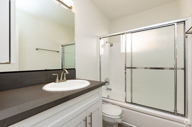 Modern styled bathroom with shower and tub. - Woodbridge Park