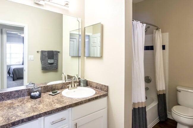 Bathroom with Large Vanity and Tub - Reflections on Sweetwater Apartments