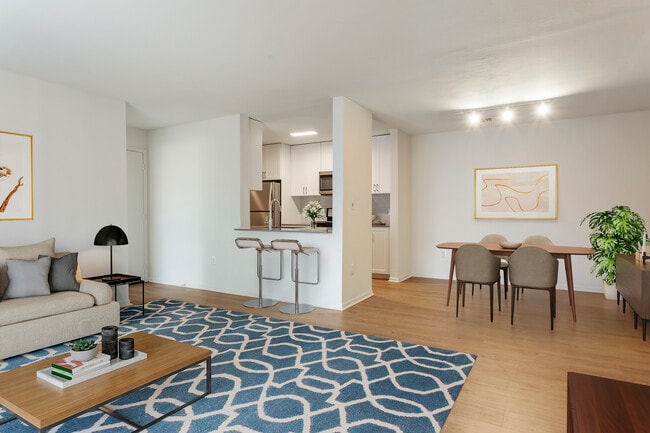 Renovated Package I kitchen, living, and dining areas with hard surface flooring
