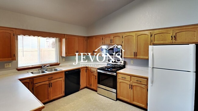 Photo - Enjoy this 3-bedroom home featuring a fully equipped kitchen, a two-car attached garage, and a fe...