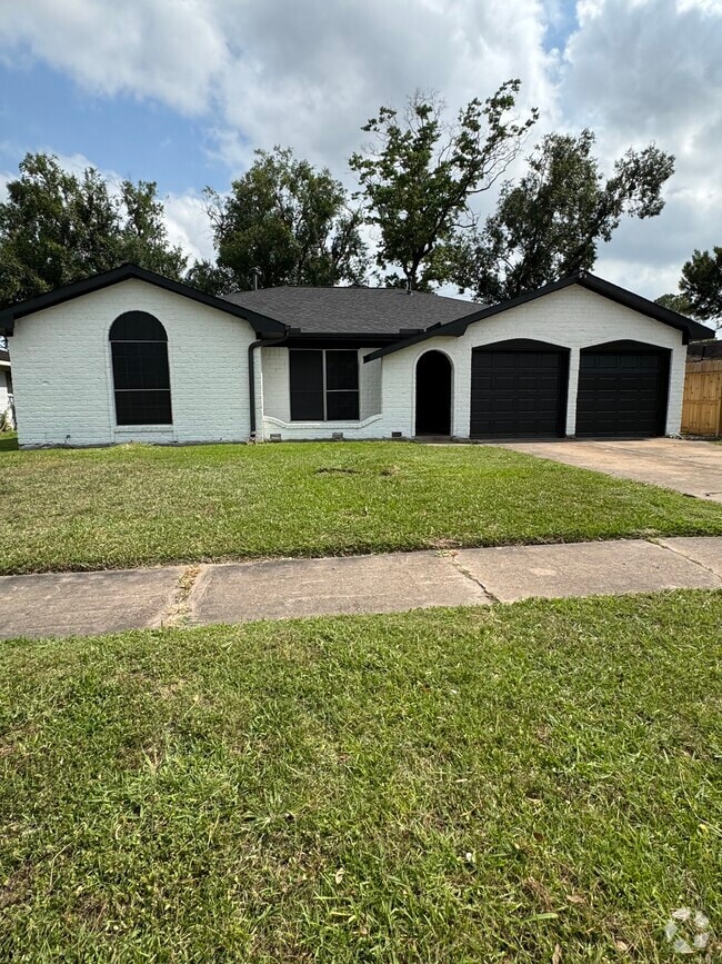 Freshly painted exterior with black accents and two-car garage curb appeal. - 11927 Troulon Dr Rental