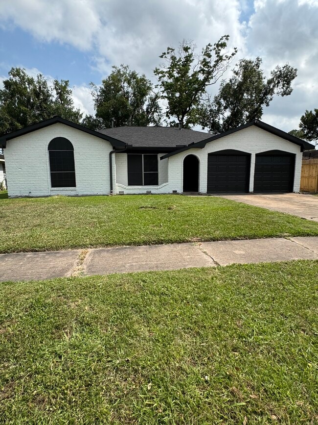 Freshly painted exterior with black accents and two-car garage curb appeal. - 11927 Troulon Dr House