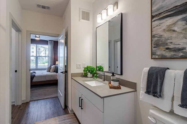 Get ready in style at the quartz-topped vanity, thoughtfully positioned just off the bedroom for an easy everyday flow.