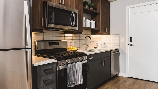 Kitchens with stainless steel appliances and custom cabinetry with chrome pulls