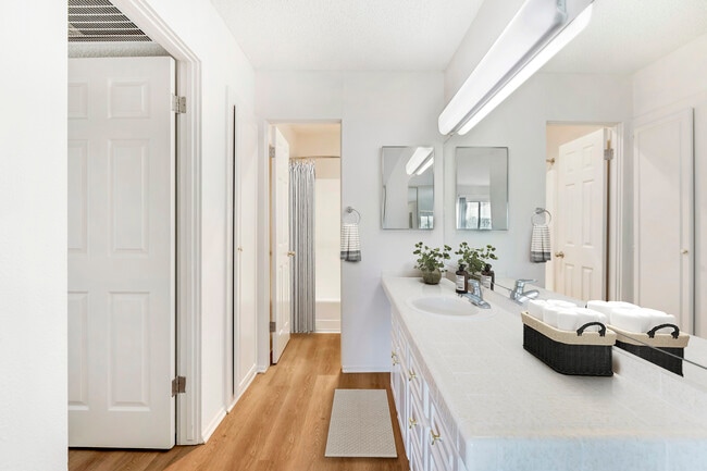 Classic Package II bath with white tile countertops, white cabinetry, and hard surface flooring