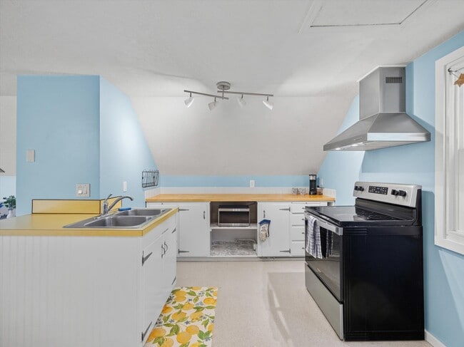 The spacious kitchent includes modern, stainless appliances. - 9835 SW 80th Ave