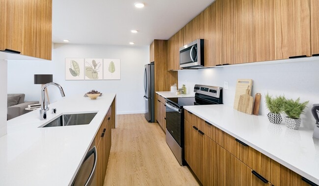 This bright and spacious kitchen blends form and function - 707 Leahy Apartments