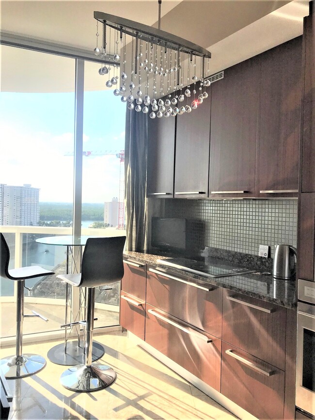 Kitchen with European Cabinetry and crystal chandeliers - 15901 Collins Ave Condominio Unidad 1205