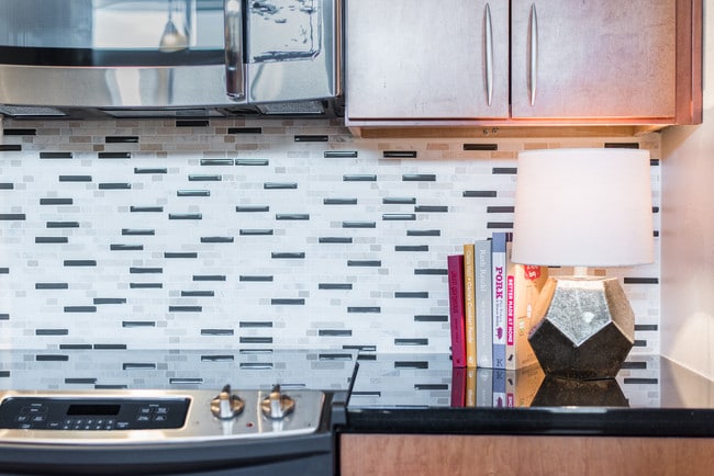 Kitchens with stainless steel appliances and tile backsplash