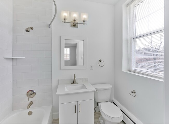 Bright and modern bathroom with updated fixtures and sleek tilework at Crestwood Apartments in Wayne, PA