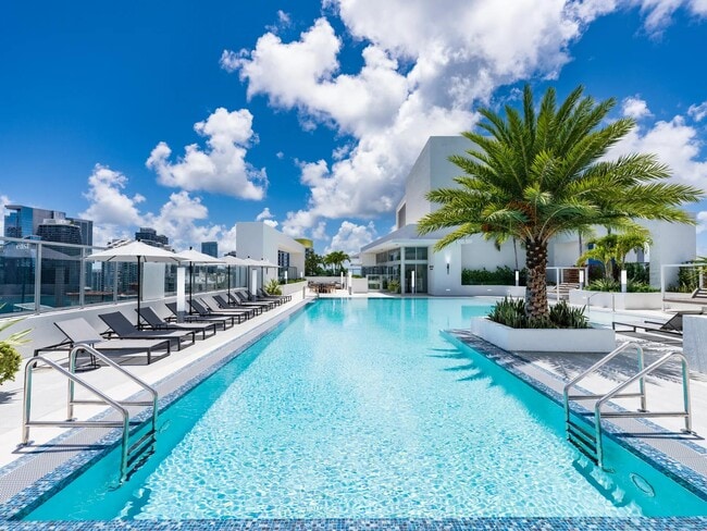 Dive into resort-style living at Modera Riverside’s rooftop pool surrounded by stunning Miami views. - Modera Riverside