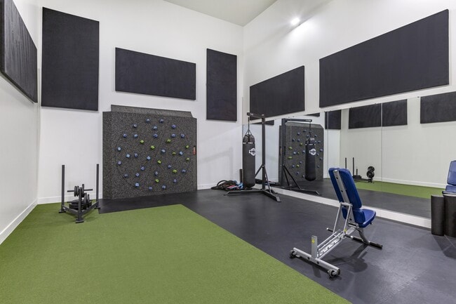 Experience our state-of-the-art gym featuring a dynamic climbing wall and exercise equipment