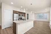 Modern kitchen with island and open layout.