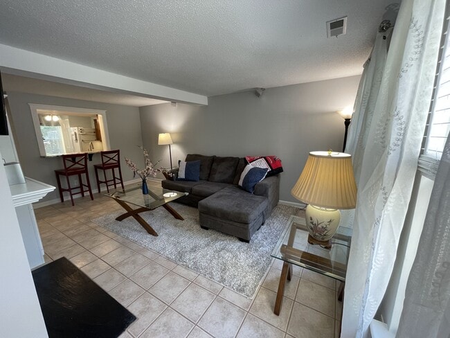Living Room from Entrance with tile throughout downstairs. Pictures are as unit will be furnished. - 4204 Whistler Ct