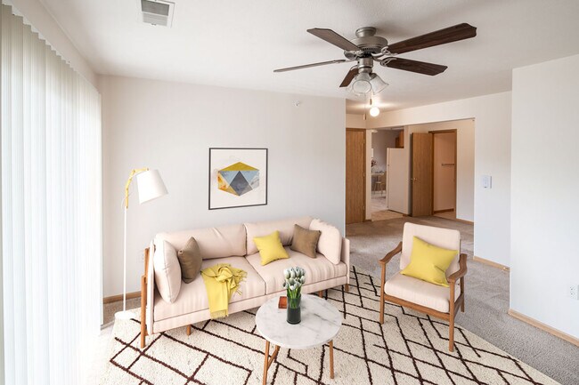 Highland Meadows Apartments in Bellevue, NE Stylish Living Space with Vertical Window Blinds & Ceiling Fan