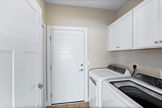 Laundry Room w/ Full Size Washer and Dryer going into 2 car attached Garage