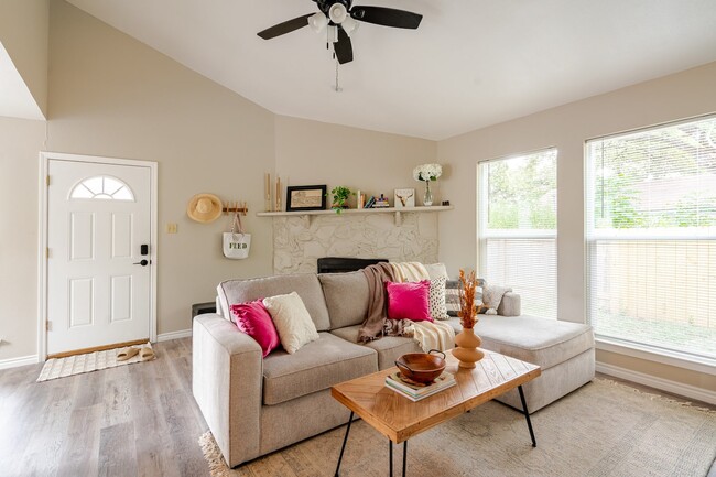 Living room with Fireplace, large window and new blinds throughout. - 6307 Okner Ln Rental
