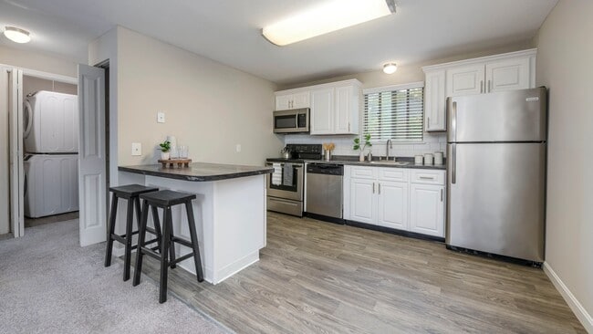 The Woodhaven Kitchen is where charm meets function, with wood-style flooring and inviting granite-style countertops.