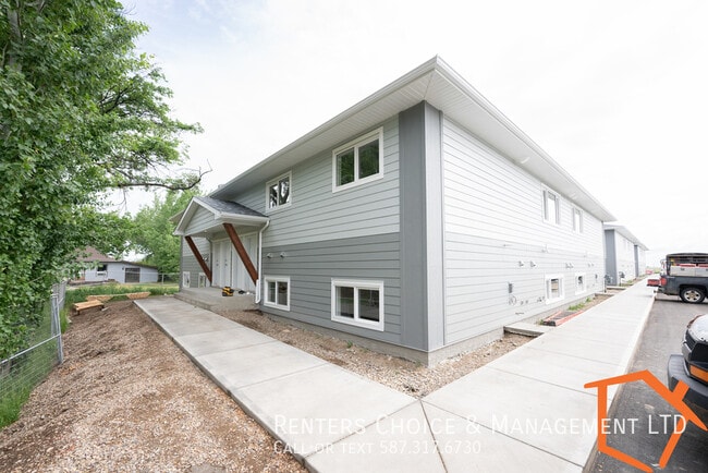 Building Photo - NEW 2 BEDROOM MAIN FLOOR UNIT WITH ASSIGNED PARKING