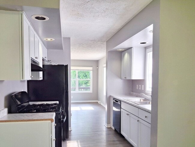 Photo - 4 Bed / 2 Full Bath House with Brand-New Kitchen, Attached Garage, and Full Basement - Built 2001