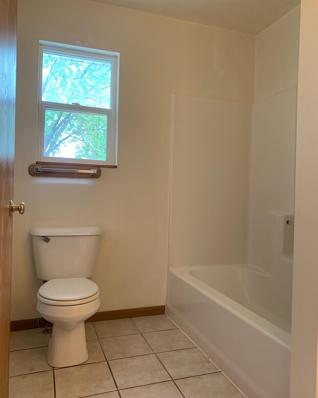 2 full baths - one up and one down. Bath feature tile flooring, new paint - very clean! - 1716 5th St E Townhome