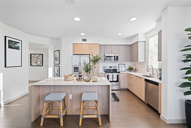 This open-concept kitchen offers the perfect blend of style and function—ideal for everything from casual meals to entertaining guests. - The Grant