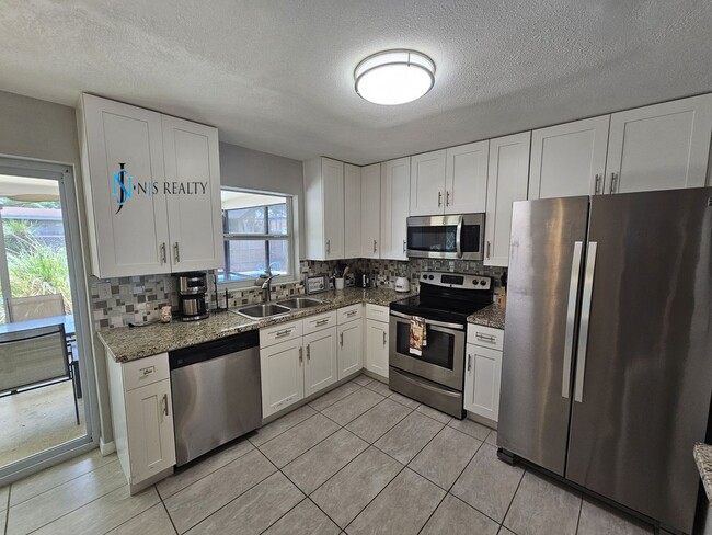 Photo - JUST REDUCED... must see beautiful 3/2 1071 Sq. Ft. with a POOL!! Gorgeous updated Kitchen & bath...