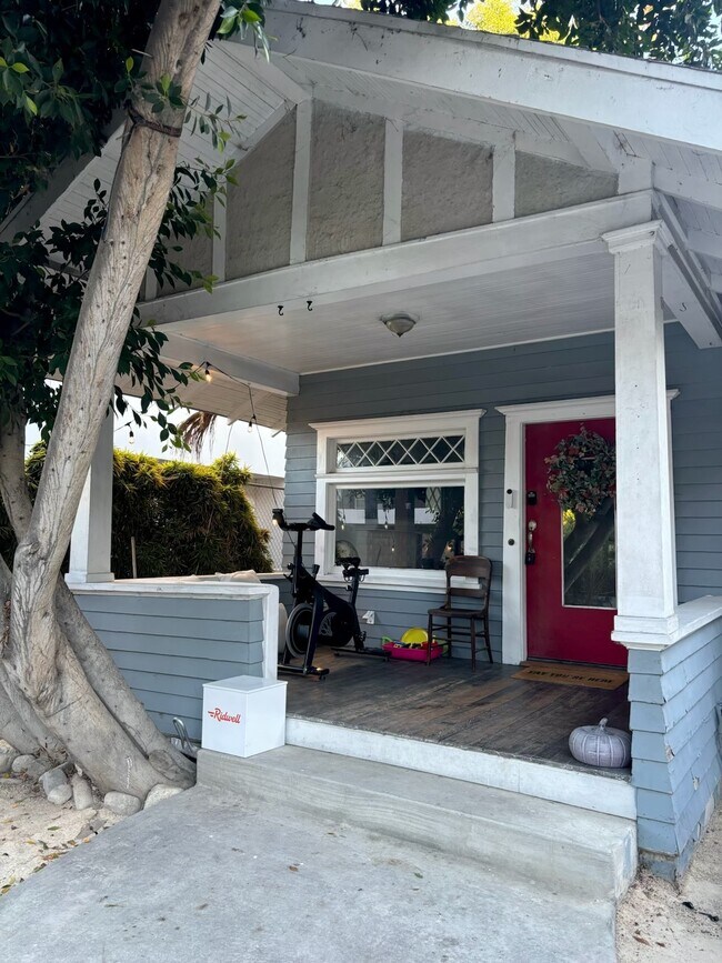 Charming covered porch with Craftsman details and space for outdoor seating or exercise equipment. - 6000 Carlton Way