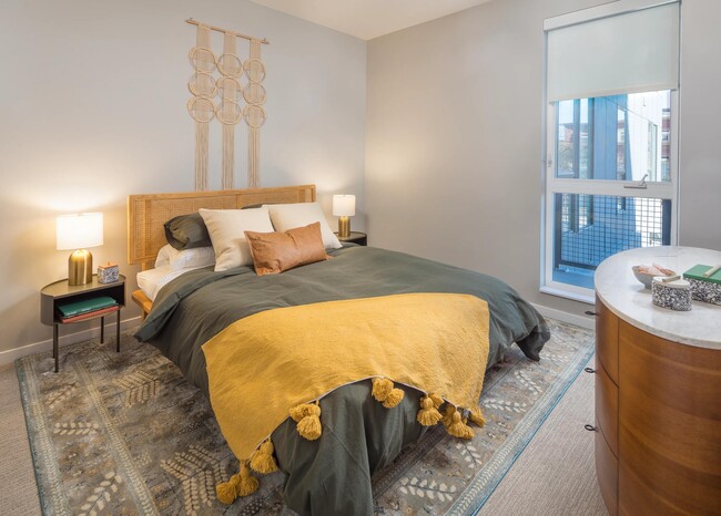 Spacious bedrooms with custom roller shades.