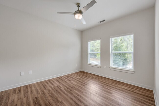 Bedroom with windows and ceiling fan