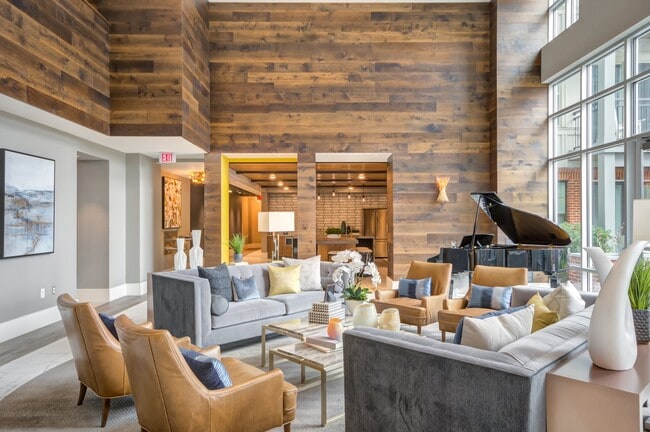 Inviting resident lounge with plush seating, a grand piano, and a warm, modern vibe.