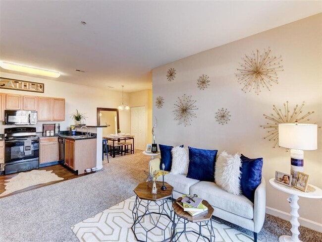 Residence at North Penn living room with hardwood kitchen flooring and lush carpet - Residence at North Penn