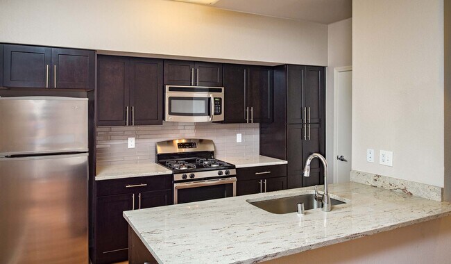 Modern kitchen with stainless steel appliances, granite countertops and premium cabinetry