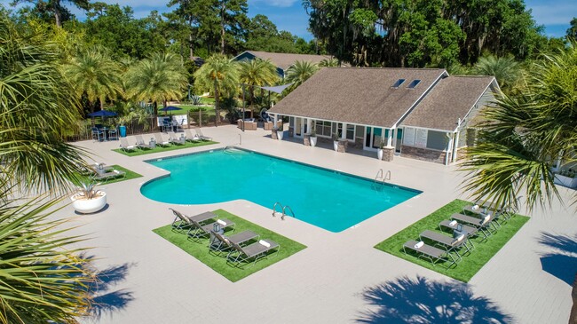 Immerse yourself in relaxation and luxury amidst the sparkling blue waters and sun-kissed loungers at our resort-style pool deck. - Emerson Isles Apartments