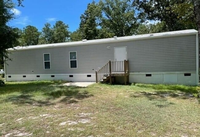 Photo - Single wide trailer on block foundation - ...