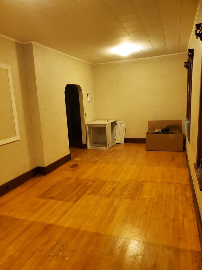 living room leading to dining room - 606 7th St N Unit One
