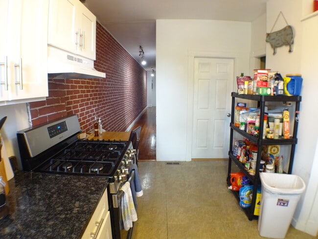 Kitchen looking back down the hallway towards the front door.