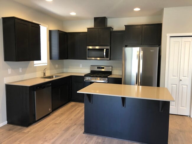 Kitchen with quartz countertops and stainless appliances - 20556 SE Evian Ave