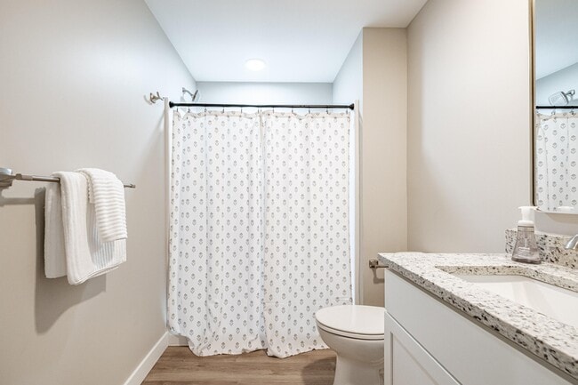Enjoy the convenience of a private ensuite bathroom with a spacious walk-in shower, stylish finishes, and a thoughtfully designed vanity area.