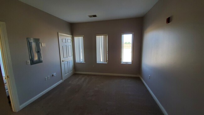 Bedroom with Blinds - Uptown Brass Apartments