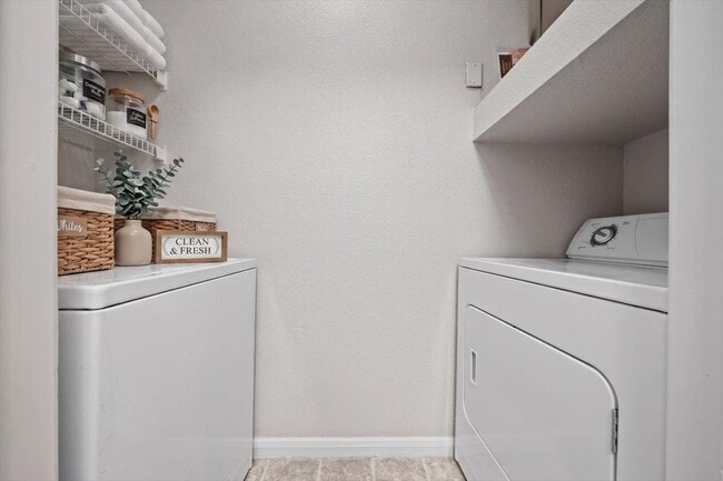 Skip the laundromat—this home features a full-size washer and dryer with built-in shelving for easy, everyday convenience.